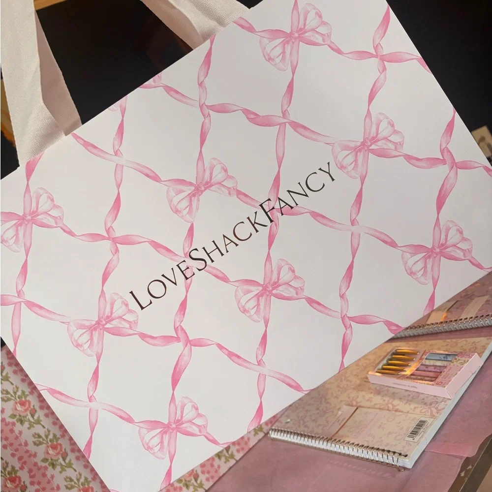 LoveShackFancy pink shopping gift bags with pink ribbon bow pattern